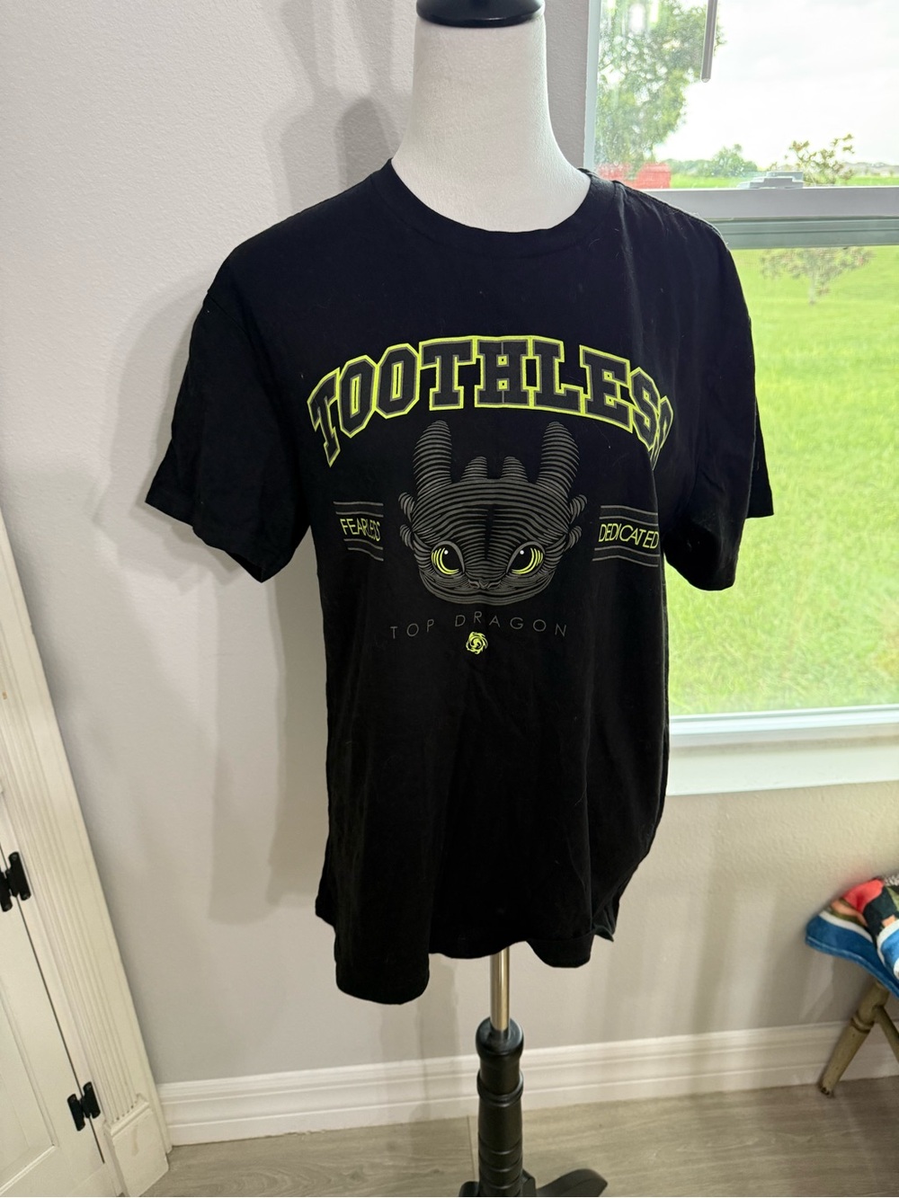 Dreamworks Black Tee with Neon Yellow Toothless Graphic